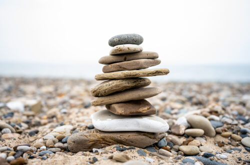 Stacked flat stone carin on rocky beach