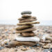 Stacked flat stone carin on rocky beach